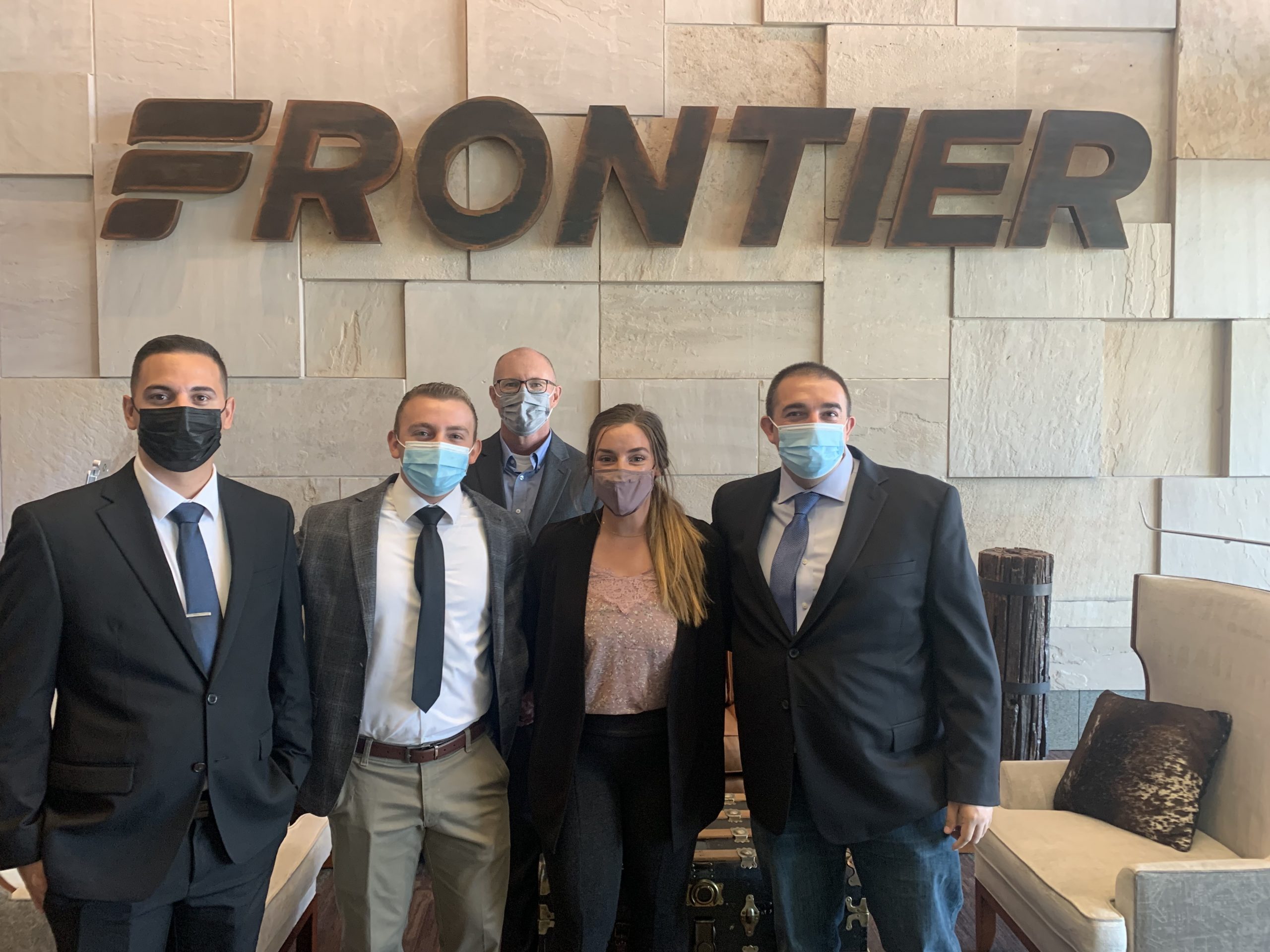 Direct Connect Flight Academy and Frontier Airlines Team Members pose for a photo together.